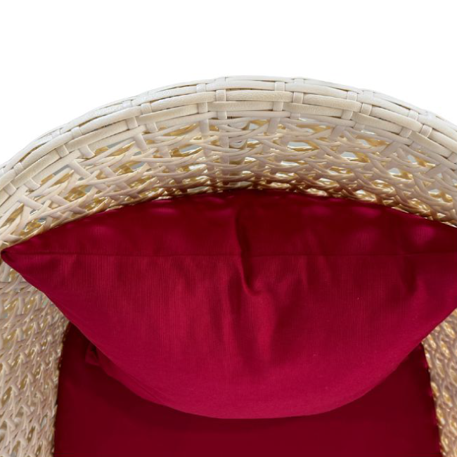 Close-up of a wicker chair with a red cushion on a white background