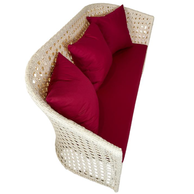 Wicker chair with red cushions on a white background
