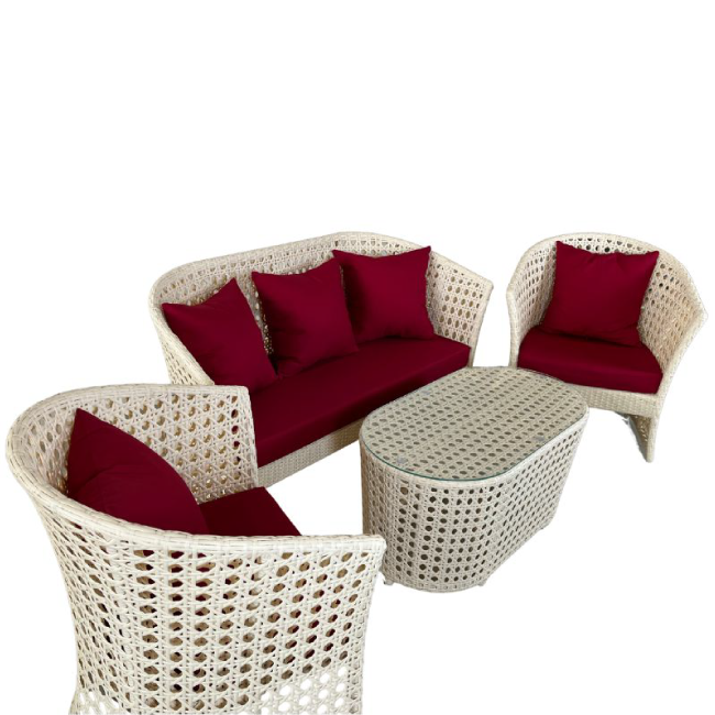 Wicker outdoor furniture set with red cushions on a white background
