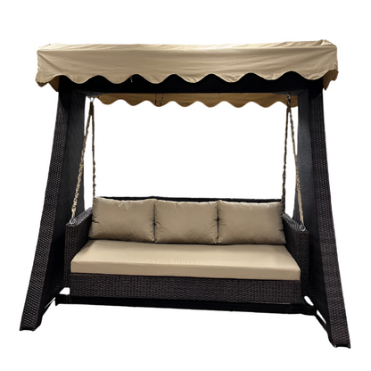 Wicker swing bed with canopy and beige cushions on a white background