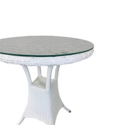 Round white wicker table with a glass top on a white background