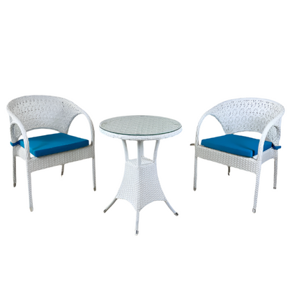White wicker chairs with blue cushions and a matching table on a beige background