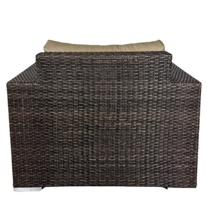 Wicker outdoor furniture piece with beige cushion on a white background