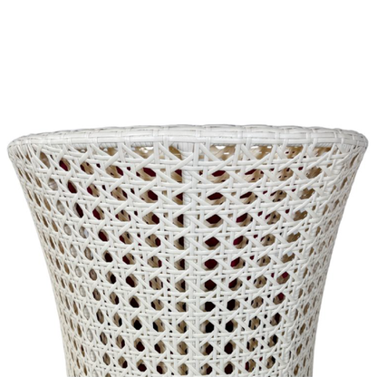 Wicker outdoor furniture set with red cushions on a white background