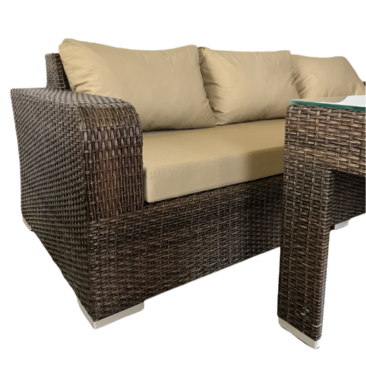 Wicker outdoor furniture set with beige cushions on a white background